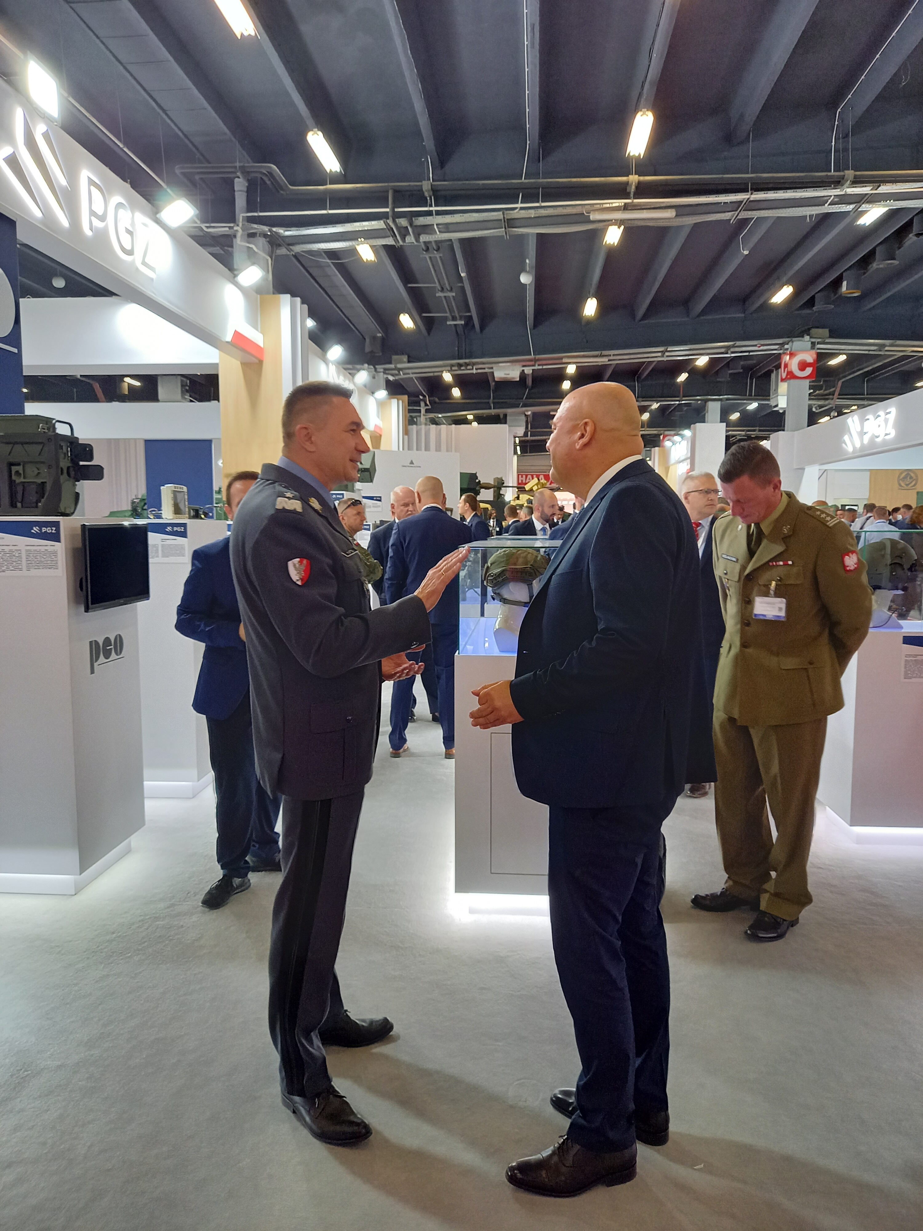 Visitors at the PCO S.A. stand during the first day of MSPO